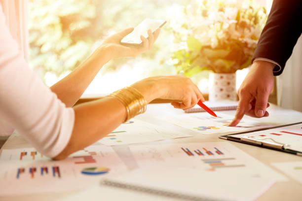 istock Team members discussing data at meeting. Graphs and charts on table. Business situation 829302098