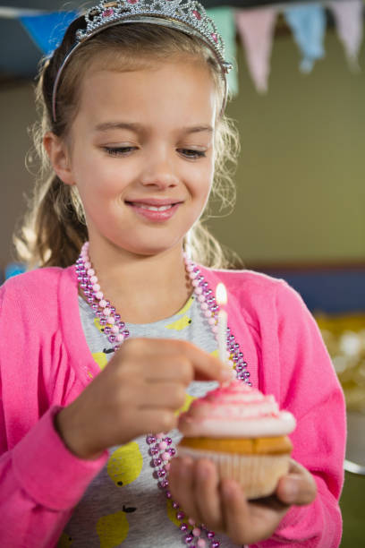 istock Birthday girl holding a cupcake 829302134