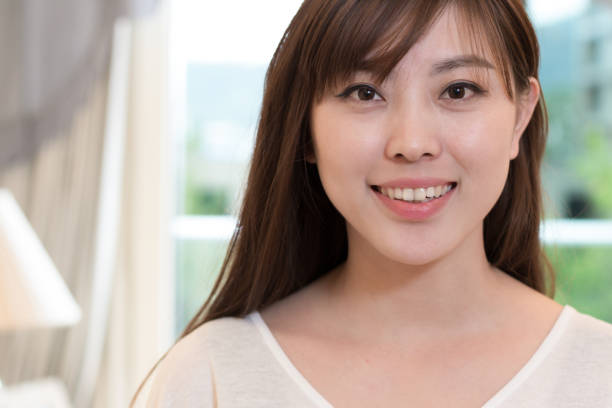 istock young beautiful asian woman near window 829303372