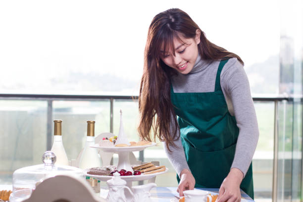 istock young beautiful asian woman near dining table 829308480