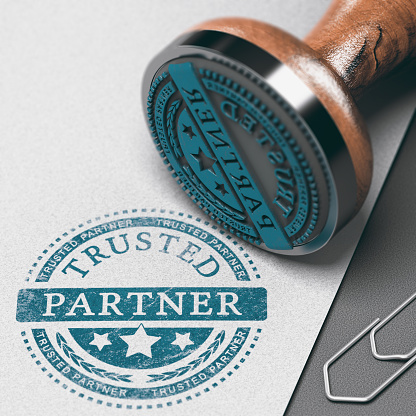 Trusted partner mark imprinted on a paper background with rubber stamp. Concept of trust in business and partnership.