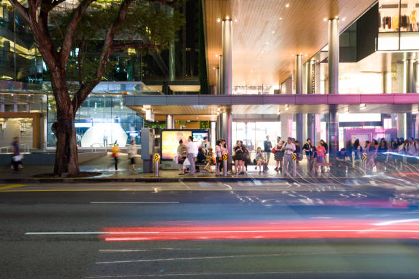night scene of bus stop with crowded people in midtown of hangzhou