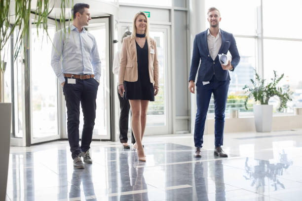 istock Business people entering lobby 829316510