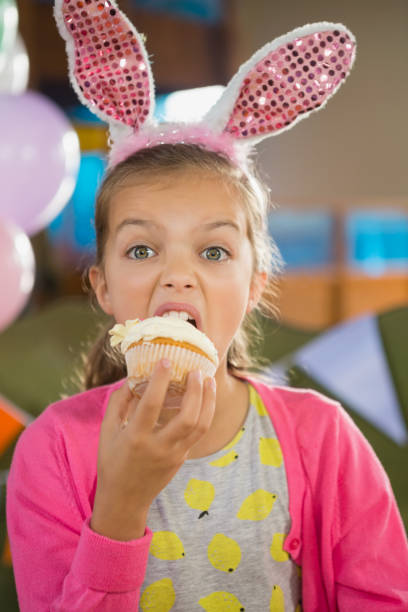 istock Birthday girl eating a cupcake 829316540