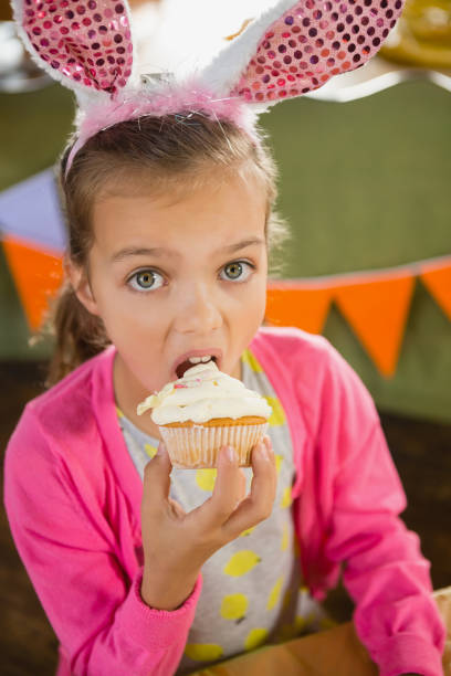 istock Birthday girl eating a cupcake 829316782