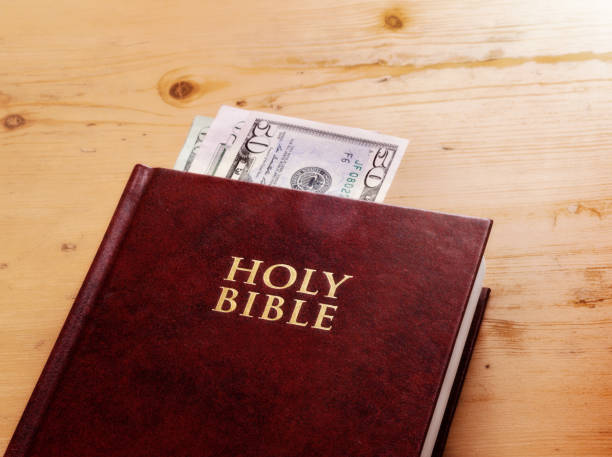 istock Holy Bible has banknotes tucked into it, donation or bribe? 829317344