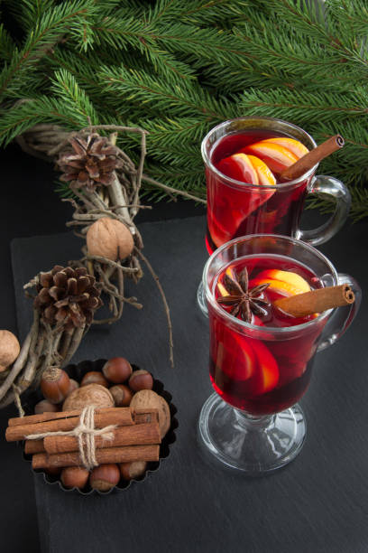 istock Christmas tradition drink. Hot Mulled wine with cinnamon and christmas tree on black slate dish. New Year. Holiday card. Close up, copy space. 829331546