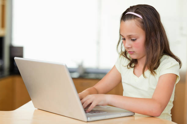 istock Little girl with laptop 829332430