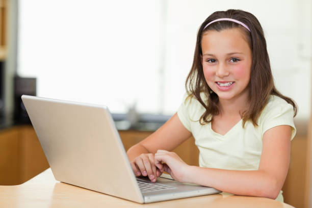 istock Smiling girl with laptop 829332514