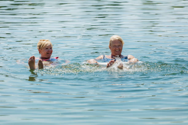 istock Senior women having fun in lake 829332752