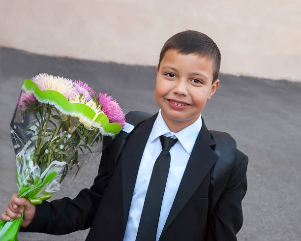 istock Schoolboy with flowers will be glad to return to school 829345448