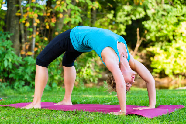 istock Young woman in nature doing yoga 829350622