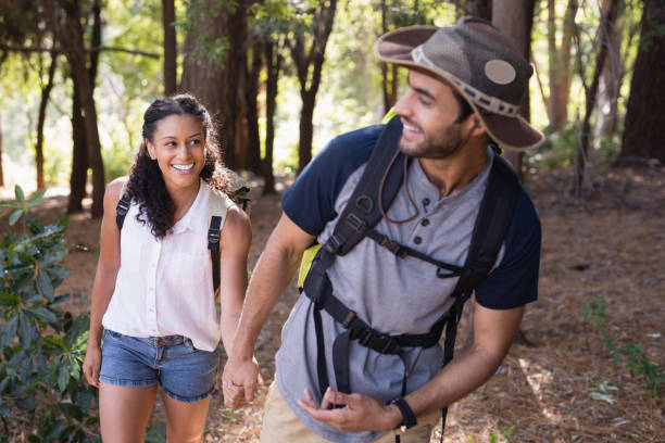 istock Happy couple holding hands in forest 829352752