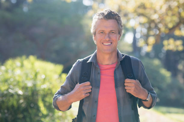 istock Portrait of happy hiker in forest 829355632