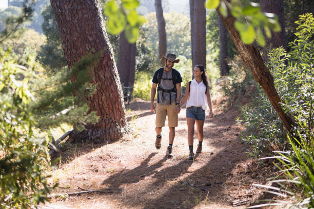 istock Happy couple hiking on trail in forest 829359144