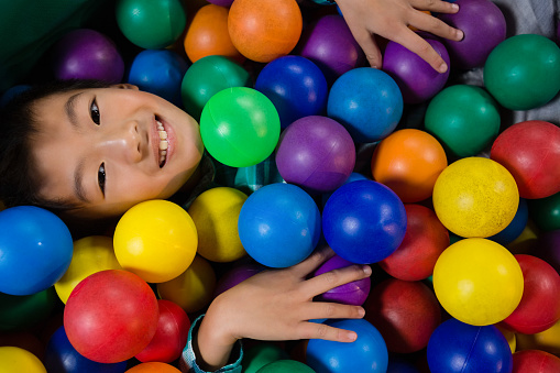Directly above portrait of smiling boy in ball pool