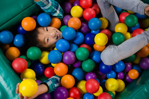 istock Overhead view of boy in ball pool 829365824