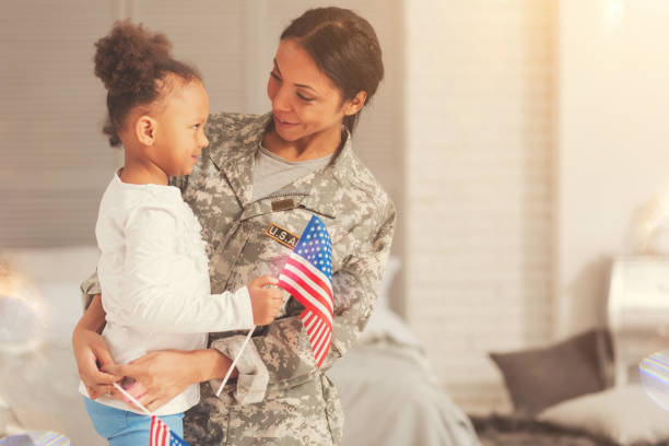 istock Military mother talking to daughter while hugging her 829379362