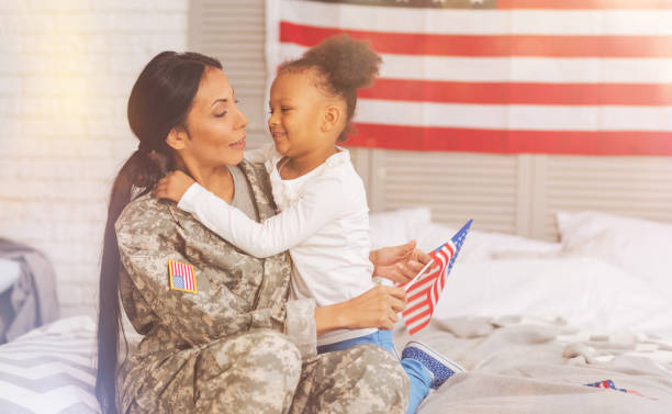 istock Sweet mother and daughter hugging one another on bed 829379858