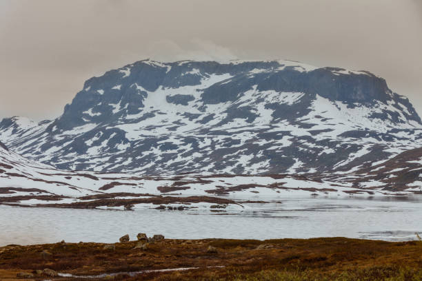 istock Norway scenic mountains with frozen lake. 829395096