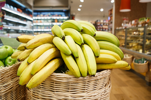 Basket with fresh ripe bananas at the grocery store.Farmer food market department in supermarket.Buy natural good vitamine products for healthy eating