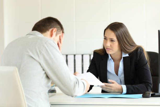 istock Sad boss firing an employee at office 829414094