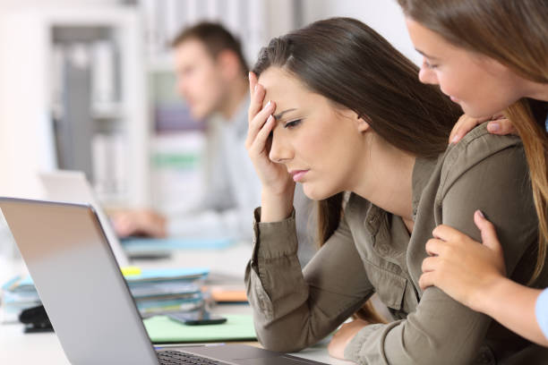 istock Sad employee being comforted by a colleague 829415108
