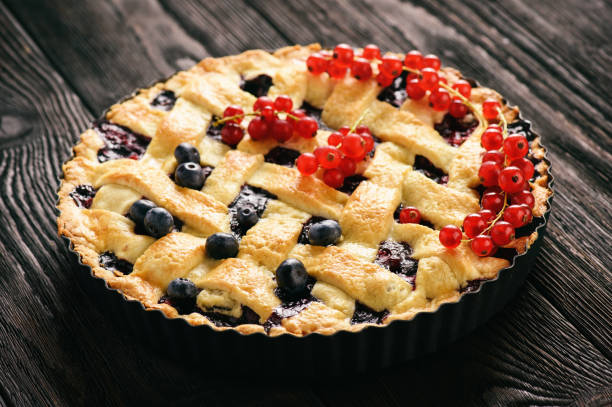 istock Homemade blueberry pie on wooden background. 829421534