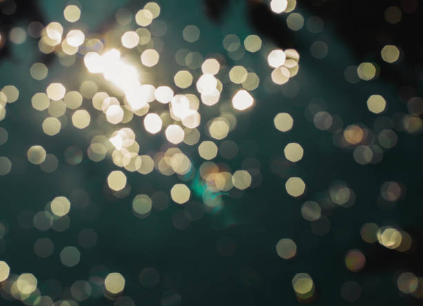 istock Vintage blur bokeh defocused teal blue colorized lights on dark room background 829422476
