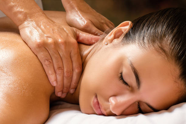 istock Woman enjoying shoulder massage in spa. 829428908