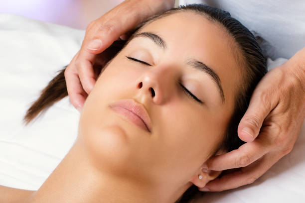 istock Therapist massaging side of female ears. 829433340