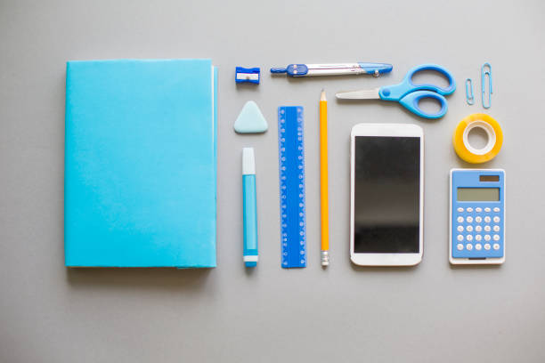 istock Blue school supplies on grey background 829436722