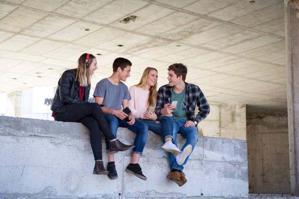 istock Group of students relaxing together at the park 829445624