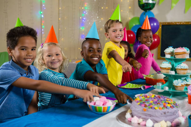 istock Portrait of children pointing on cake 829446534