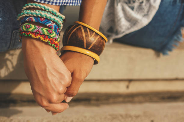 istock Close up of two women holding hands 829451818