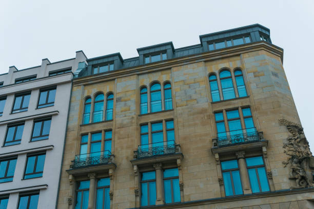 istock historical building next to typical office house 829452390