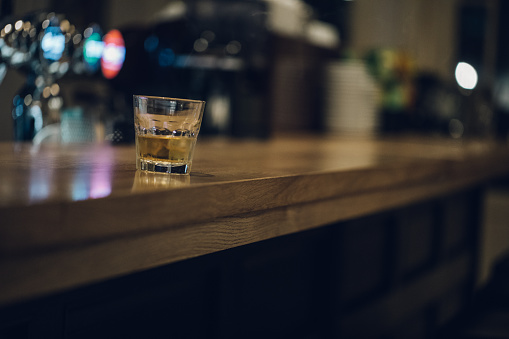 Glass of whiskey on a bar counter
