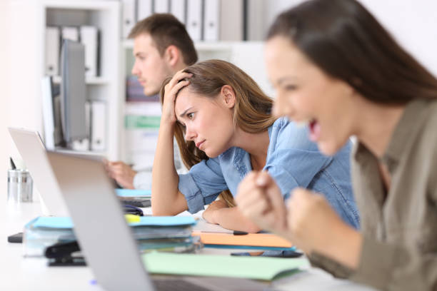 istock Frustrated employee beside successful one 829453256