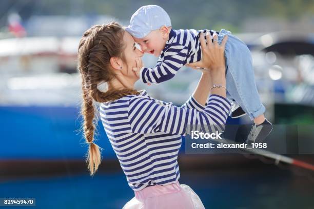Mother And Her Little Son Walking Together Along The Waterfront Stock Photo - Download Image Now