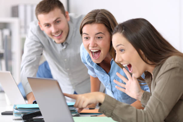 istock Three excited employees receiving good news 829460670