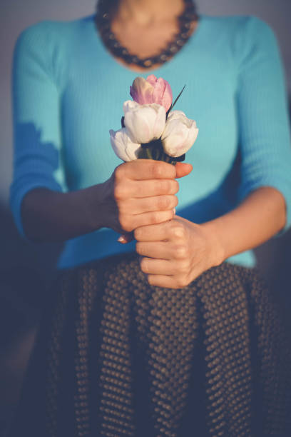 istock Woman's hand holding Flowers bouquet 829461012