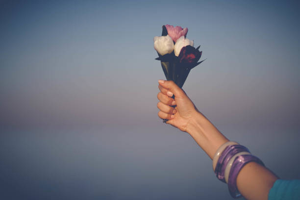istock Woman's hand holding Flowers bouquet 829461072