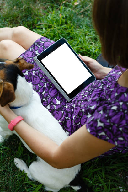 istock Woman on grass with tablet 829468970