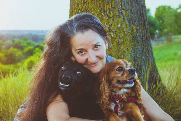 istock Active senior woman hugs dogs 829472688