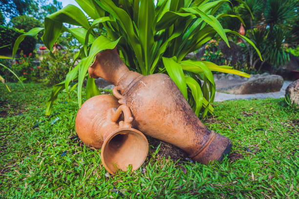 Antique vase on green grass. Asia Travel concept. Journey through Vietnam Concept.