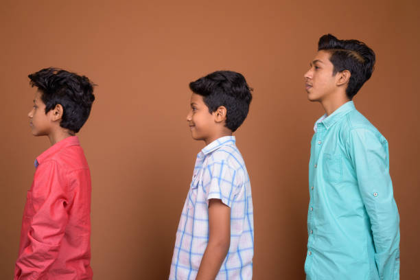 istock Studio shot of three young Indian brothers together against colored background 829481740