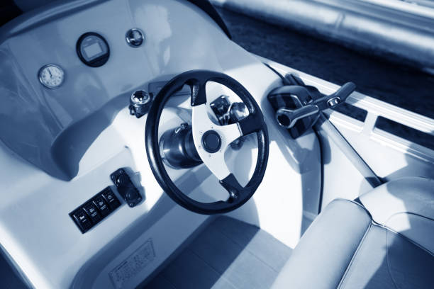 Elevated view of white modern luxury speedboat rudder control panel and leather seats in sunshine, full frame horizontal composition