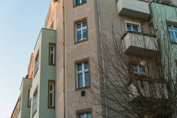 istock grey and green facaded apartment corner house 829496944