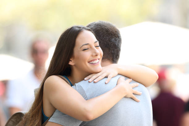 istock Couple hugging on the street after encounter 829505008