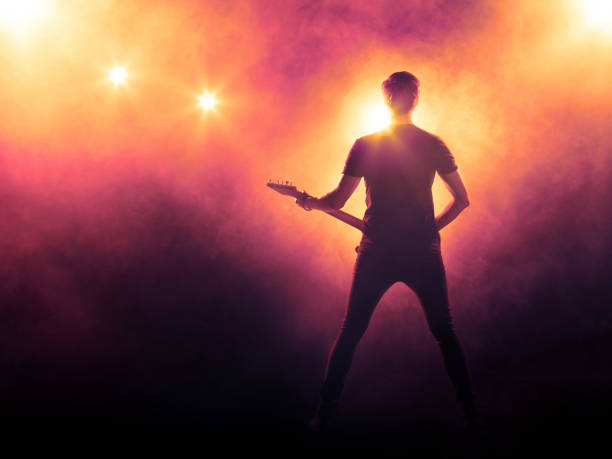 istock Silhouette of guitar player on stage 829509500